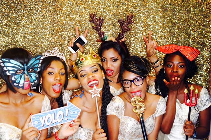 Ladies in a photo booth posing with props